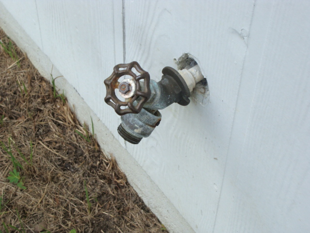 Hose faucet on exterior not properly secured to wall. This presents an increased chance for the water pipe to be broken off inside the wall.