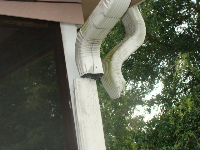 Gutters disconnected and damaged; downspouts missing and loose.