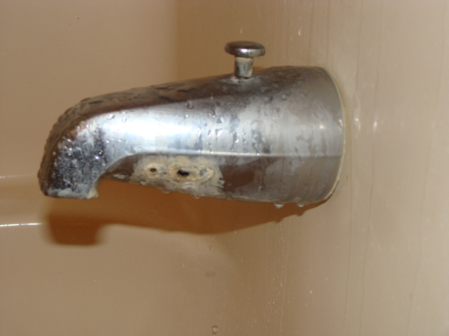 Tub spout corroded - holes appear completely through the fixture.